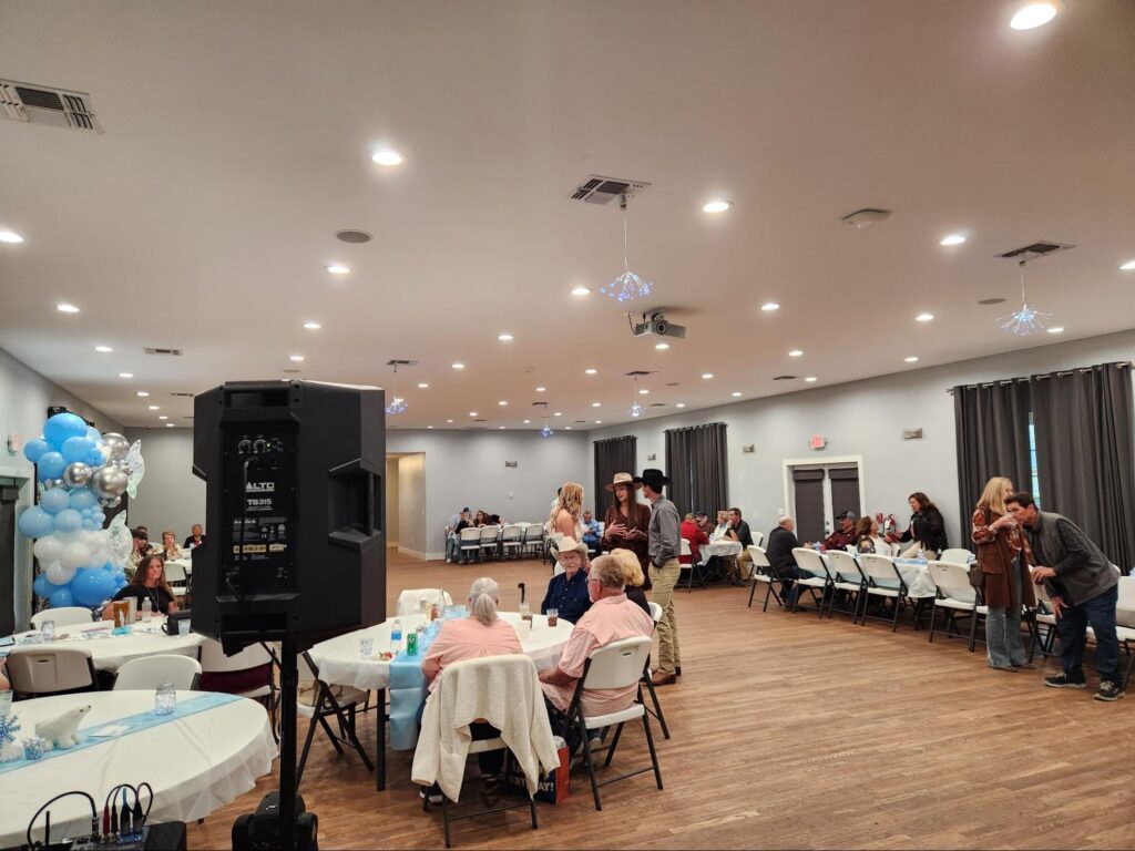 Indoor party with guests seated at tables.