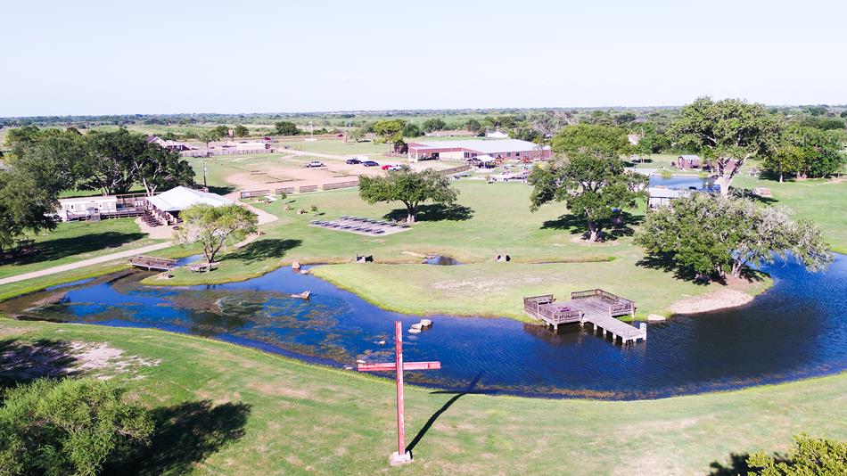 Aerial view of park with pond, docks. 