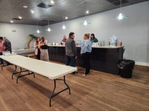 People socializing near bar in event hall.